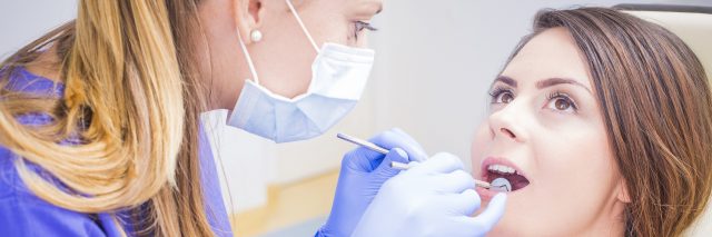 dentist cleaning a patient's teeth