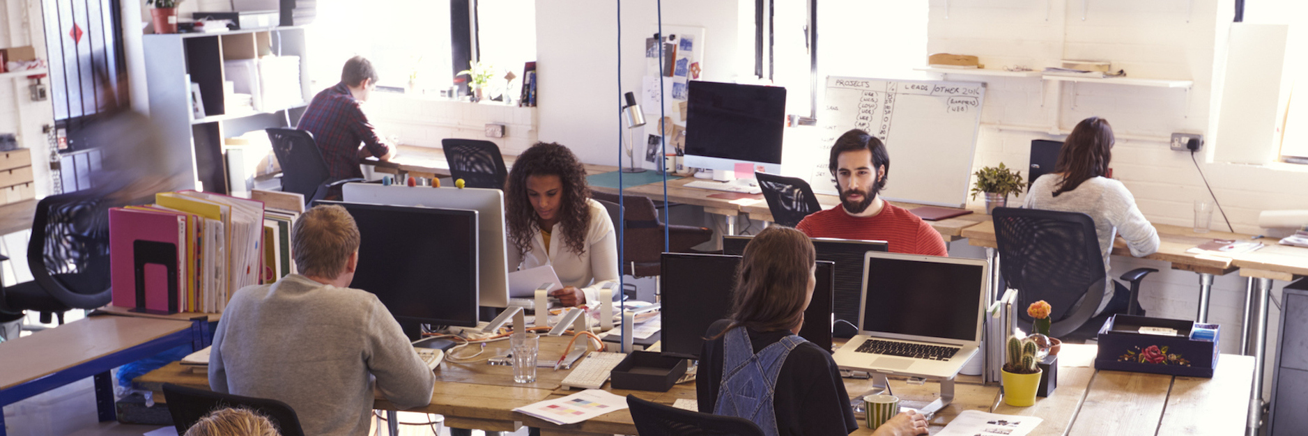 Importance of Employers Considering Autistic Employees' Needs Employees working at desks in office