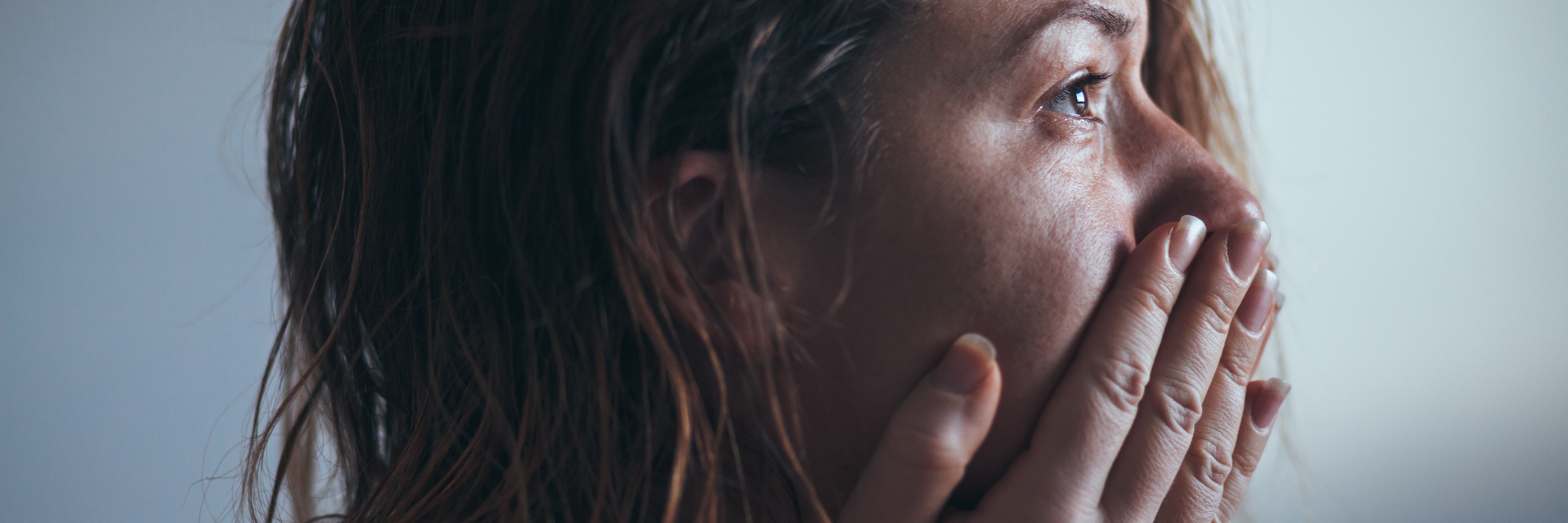 When I Feel Shame Following an Episode of Mental Illness woman with tears in eyes sitting with hands covering mouth and looking into distance