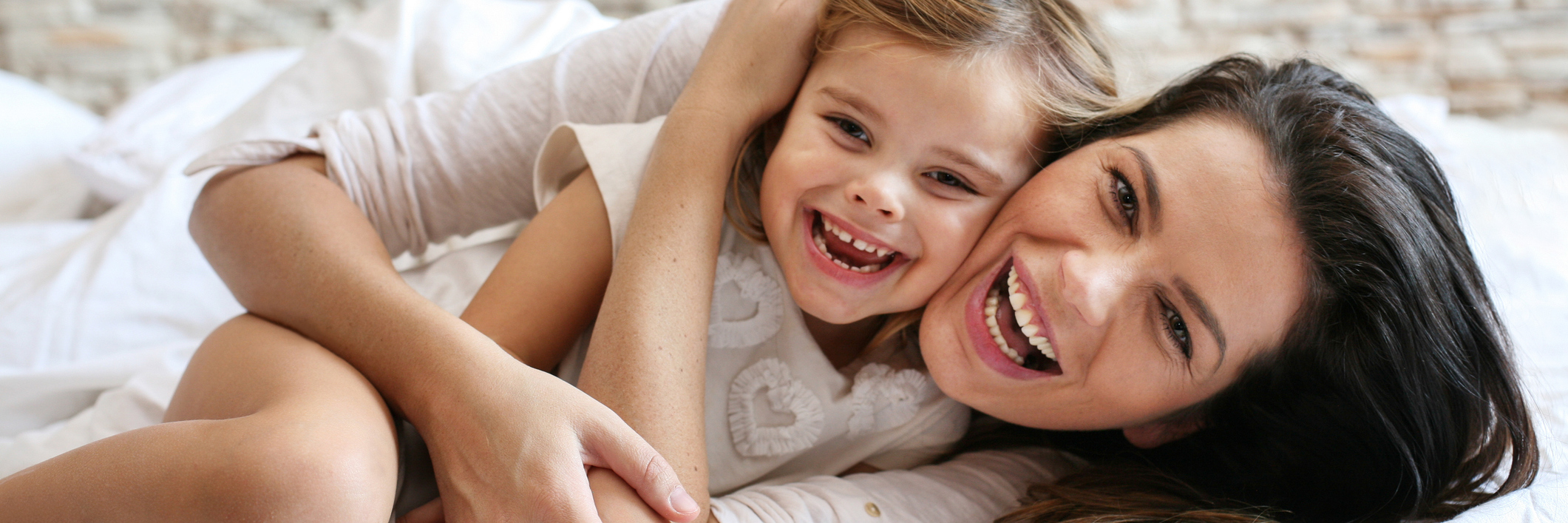 33 Things Parents Do When They Have a Child With FPIES mother and young daughter lying in bed and cuddling