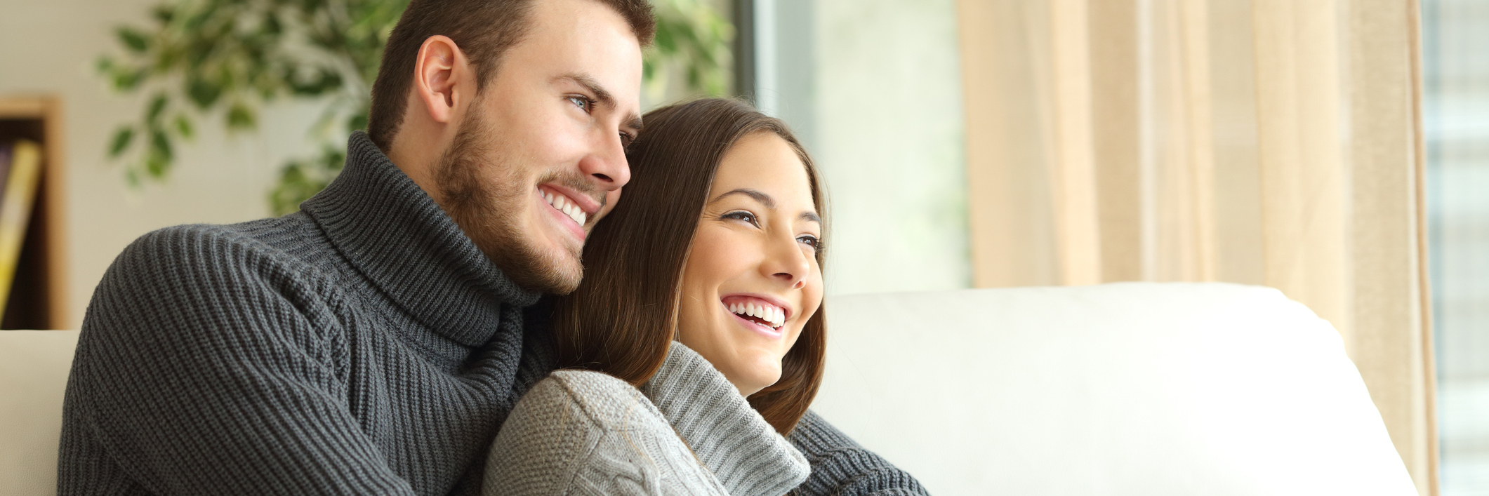 couple sitting and hugging on couch