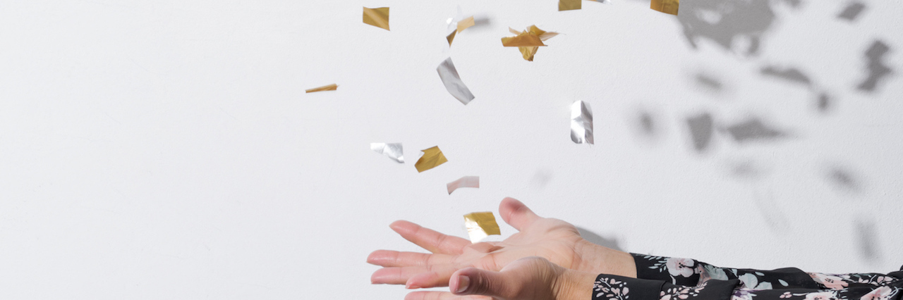 Ditching Perfectionism Improved My Mental Health a woman tossing up confetti