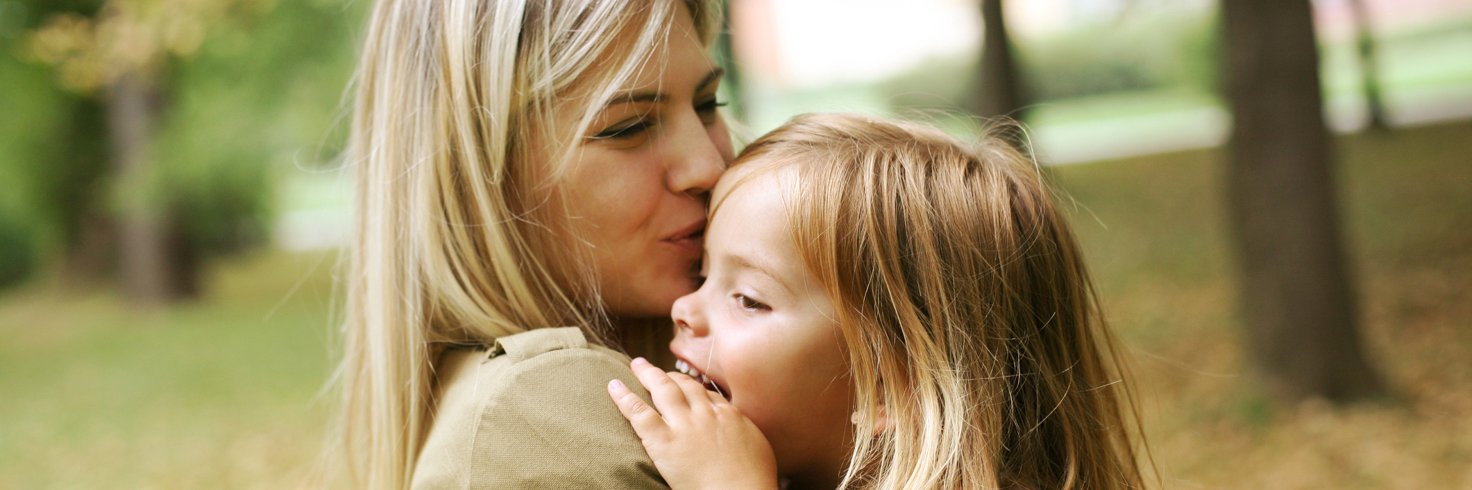 A Letter to My Daughters About My Struggles With Chronic Illness mother kissing and holding her daughter in the park