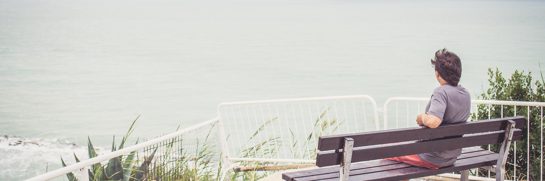 What Cerebral Palsy Has Given Me Man sitting on bench overlooking sea.