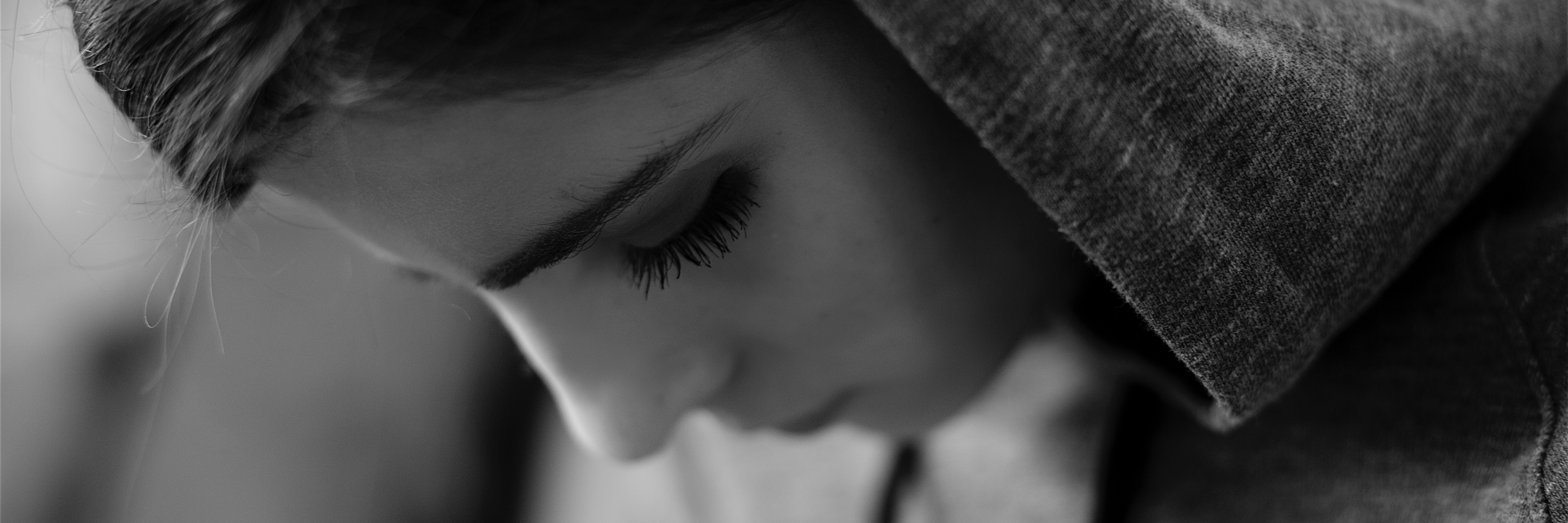 Coming to Terms With My OCD Diagnosis and the Stigma Surrounding It black and white image of unhappy woman looking down