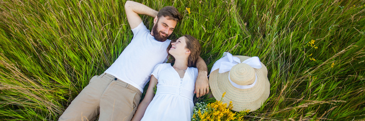 Marriage and Eating Disorder Recovery Happy young relaxed couple in love laying down on the grass overhead