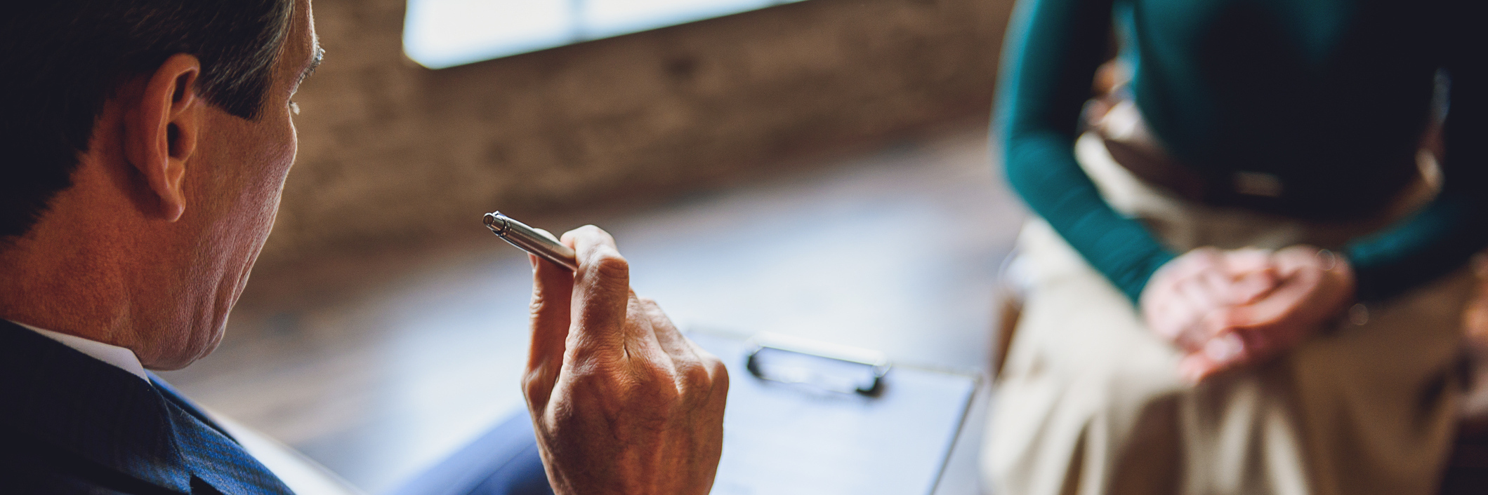 The Unexpected Thing My Psychiatrist Did for My Anxiety Senior male patient is sitting in room. He tensely thinking about information to write on. Focus on pen in hand of client