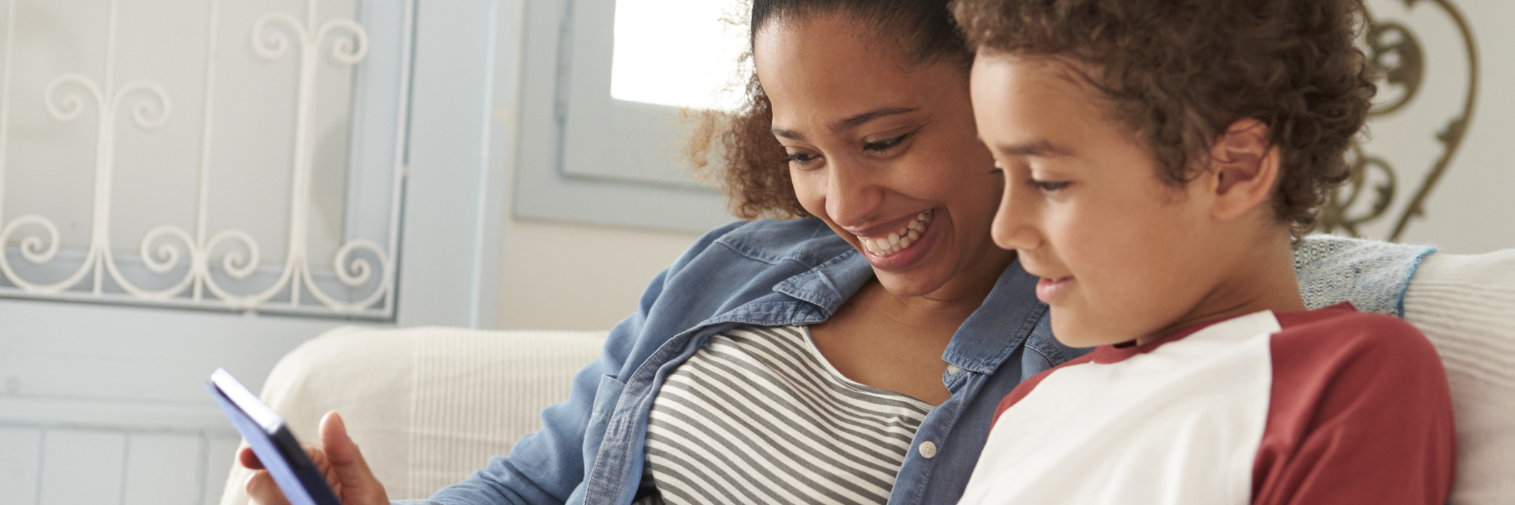 Raising a Son as a Single Mother With Chronic Pain mother and son sitting on the bed and reading together