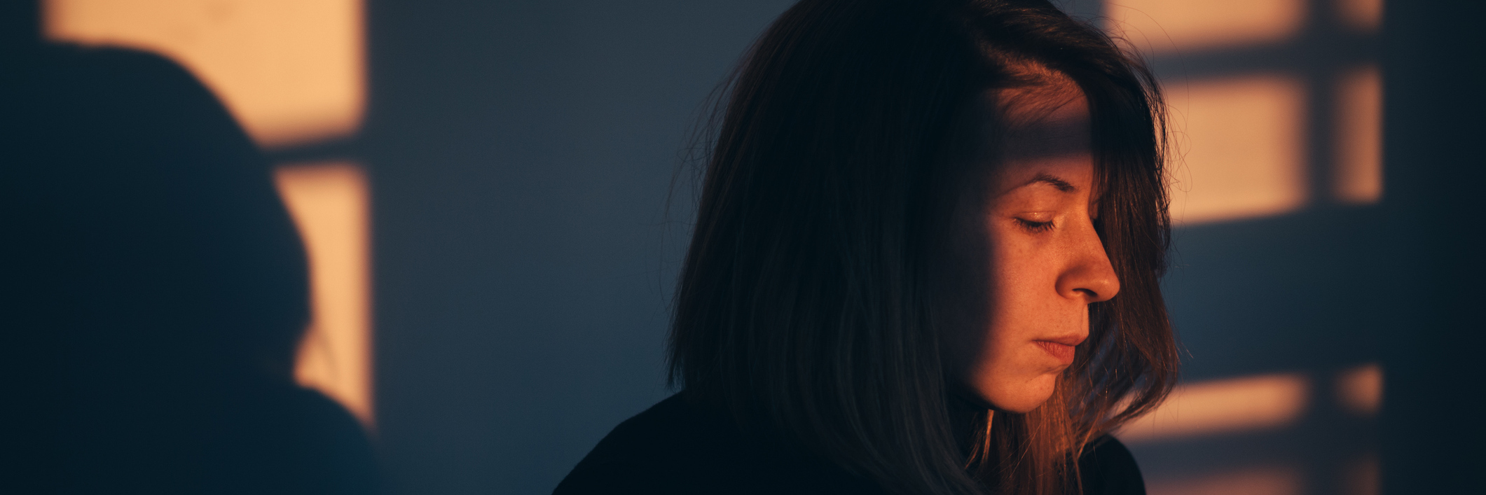 Maintaining Hope With Chronic Fatigue Syndrome A woman sitting alone and sad in window light