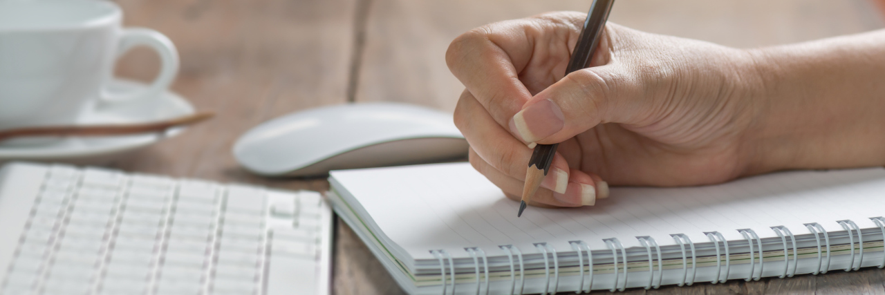 Reminding Myself of My Goals With Lyme Disease and POTS woman writing in a notebook