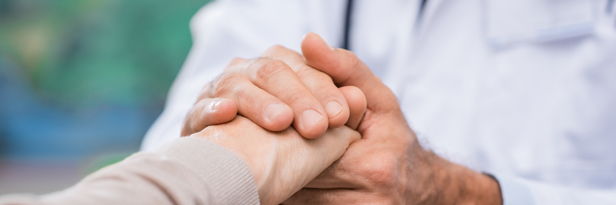 Fearing Medicare Cuts With New Healthcare Bill as Woman With Epilepsy doctor holding his patient's hand