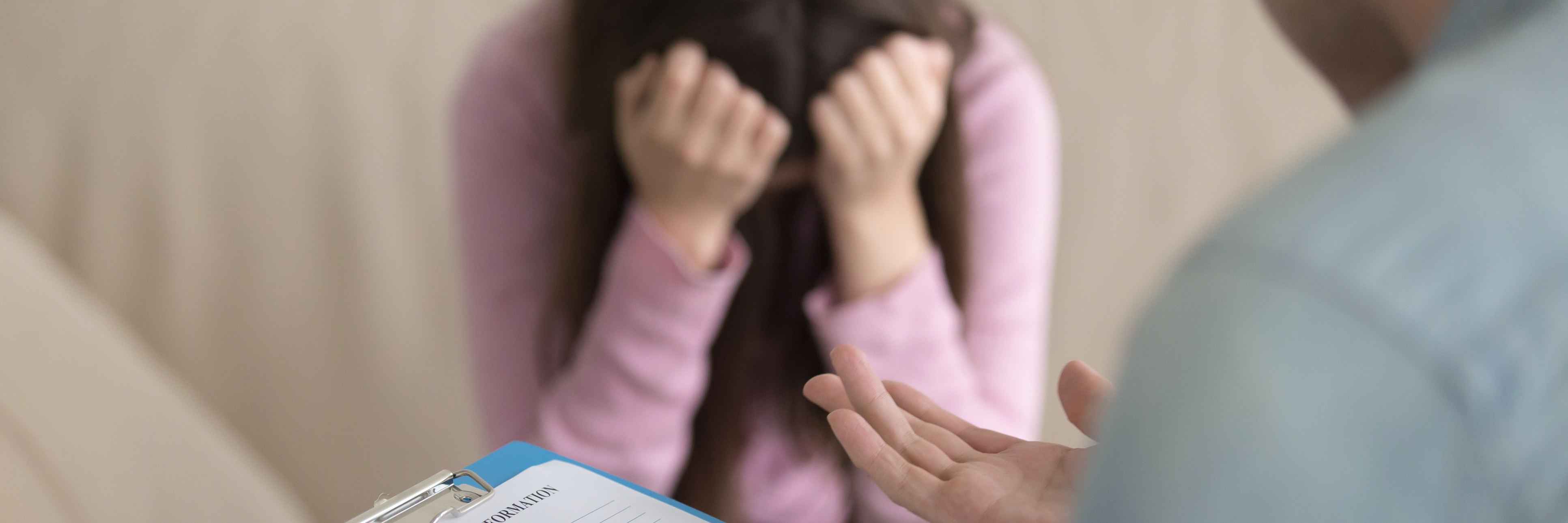 Dear Doctor: We Need to Talk About Your Poor Treatment of Me young woman with depression looking distressed in front of doctor