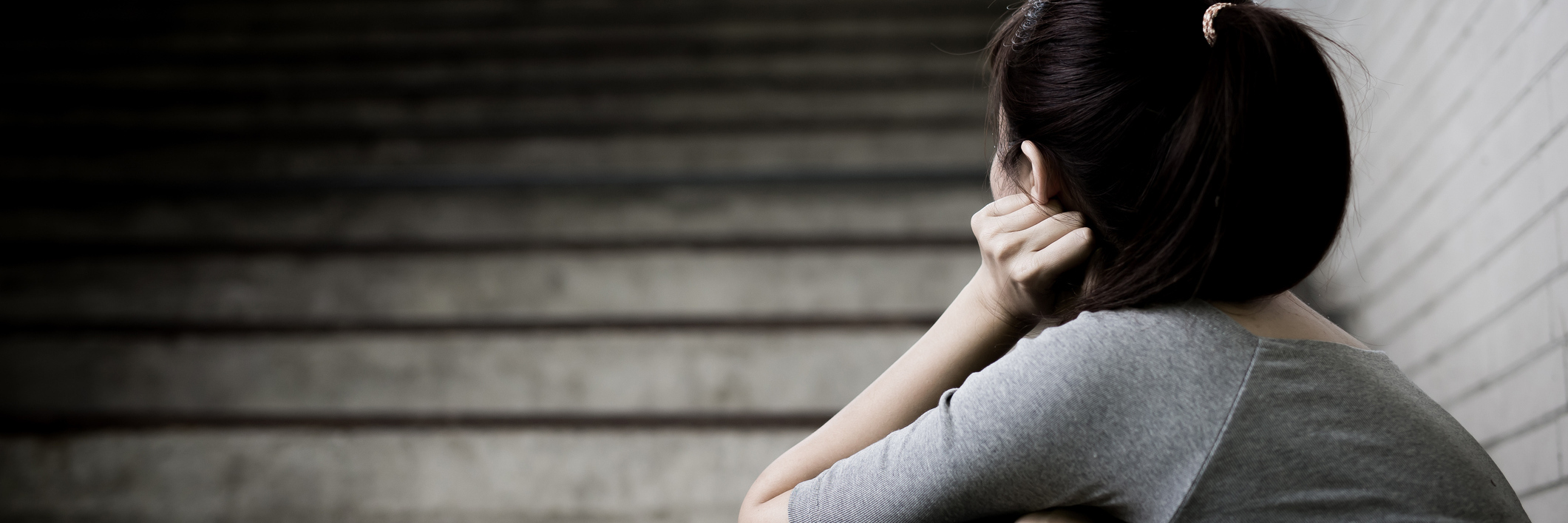 Fighting Against Depression, Despair on Tough Days With Illness woman sitting at the bottom of a staircase resting her head on her hand