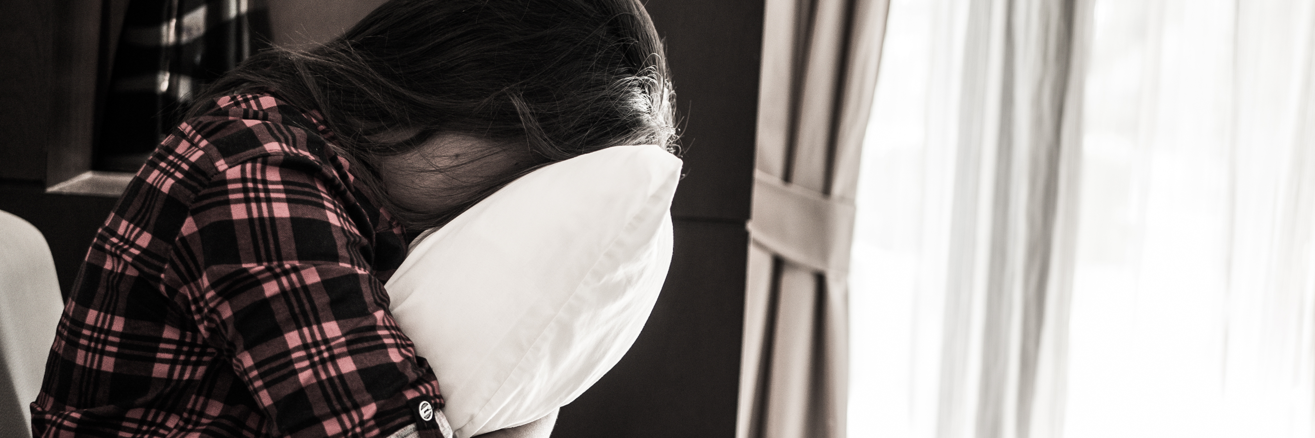 When a Low Mood Makes You Frightened Depression Is Returning sad woman hugging pillow and crying muted color