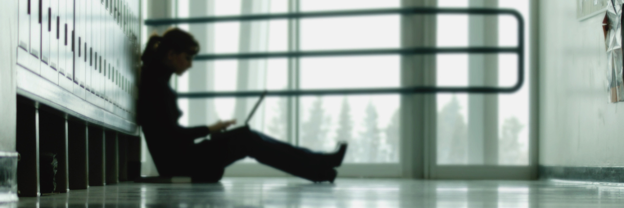 Why the Mental Health Stigma Isn't Over for High-Functioning Students Student sitting by lockers