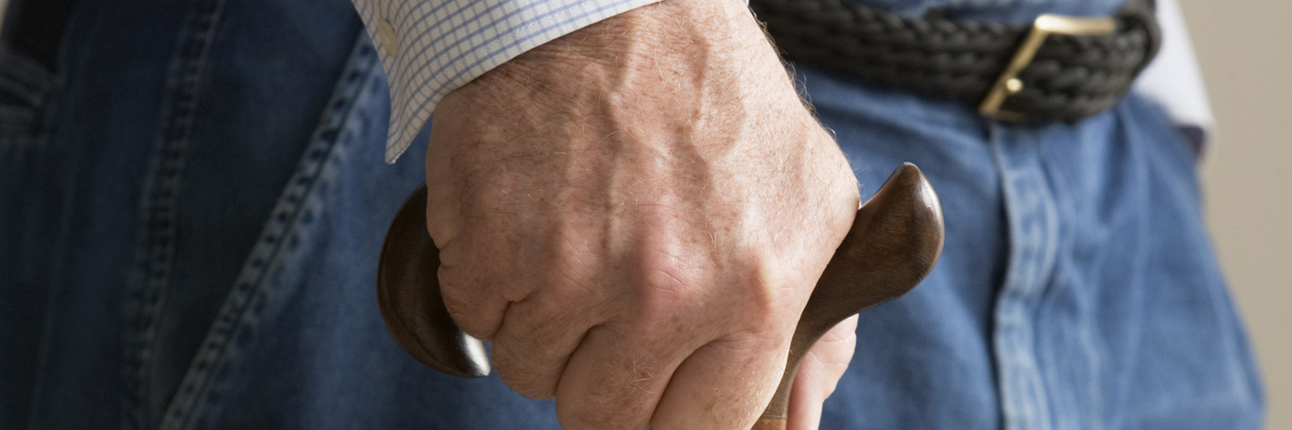 Beginning to Use a Cane in Public for Chronic Pain, Illness a man leaning on a cane