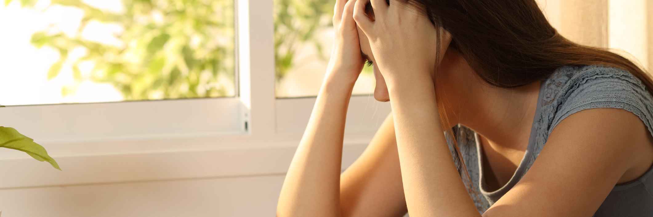 'Nothing and Everything' Are Cause of Depression sad woman at table with cup in front of her and head buried in hands