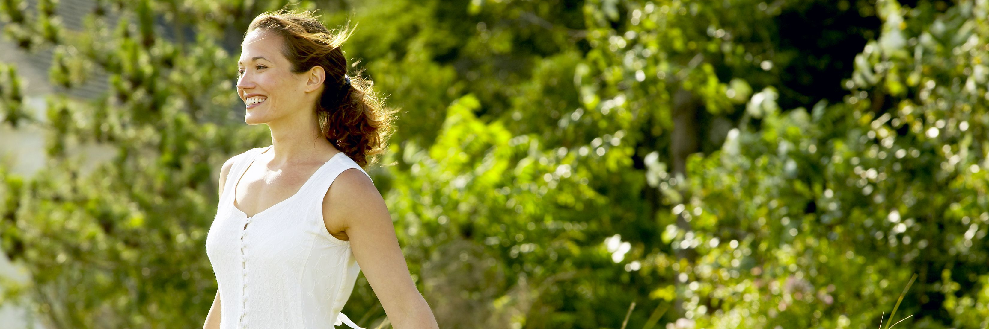 How My Lyme Disease Journey Made Me Feel Grateful for Life woman in white dress standing in a field and smiling