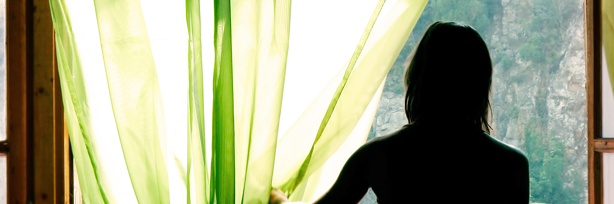 How the Weather Can Affect Your Chronic Illness Symptoms, Pain Levels silhouette of a woman standing next to a window