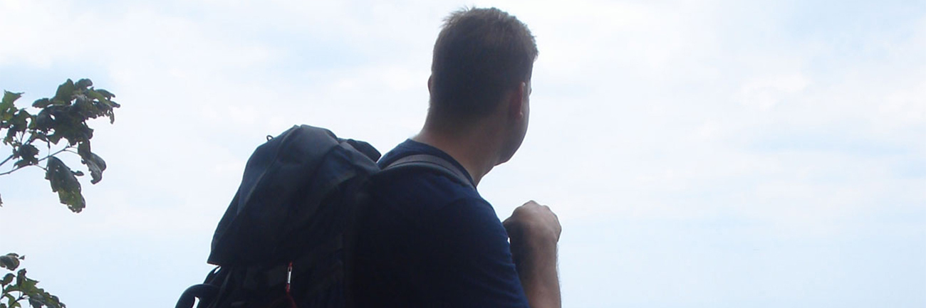 What is an Extroverted Introvert and Highly Sensitive Male man hiking looking out over vista with backpack