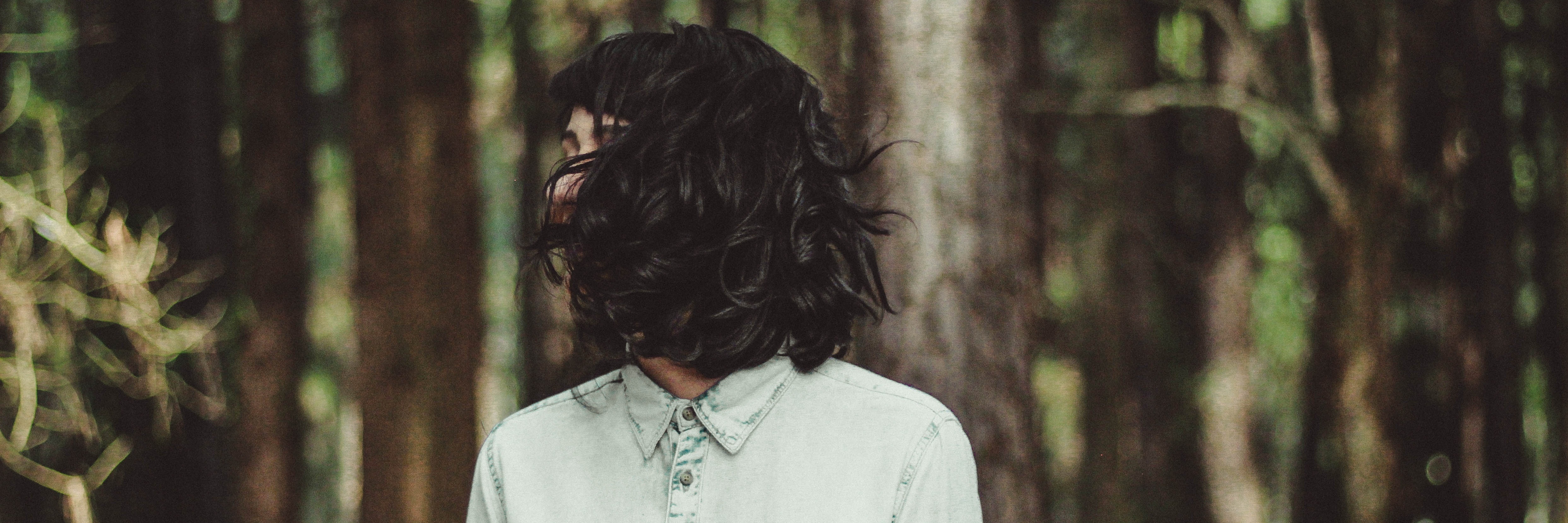 Loving With Borderline Personality Disorder and the Unexpected dark haired woman standing in forest with face hidden