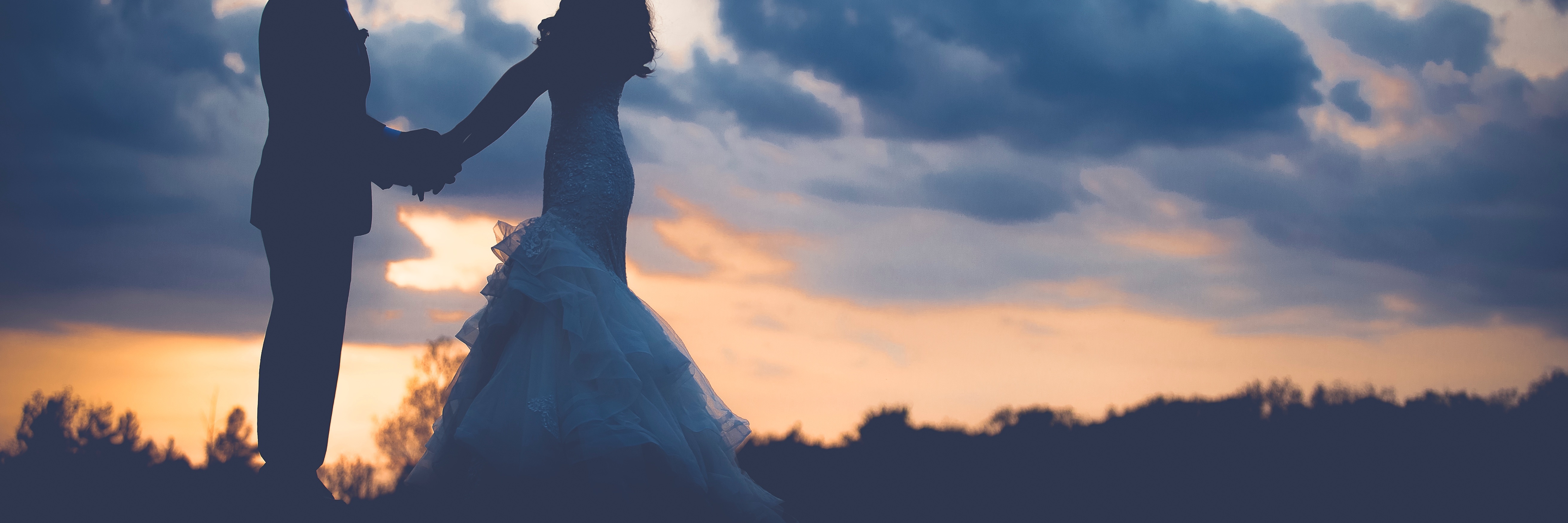 A Thank You Letter to My Wife, From Your Husband With a Mental Illness newly-wed husband and wife holding hands looking into each other's eyes silhouetted against sunset