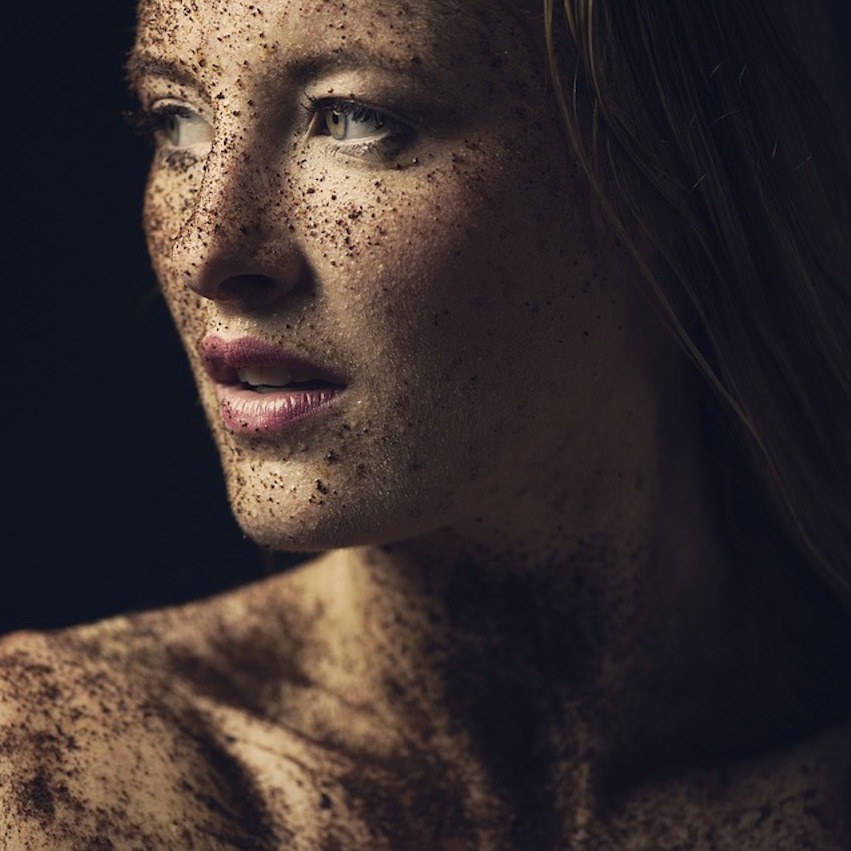 woman covered in dirt smiling
