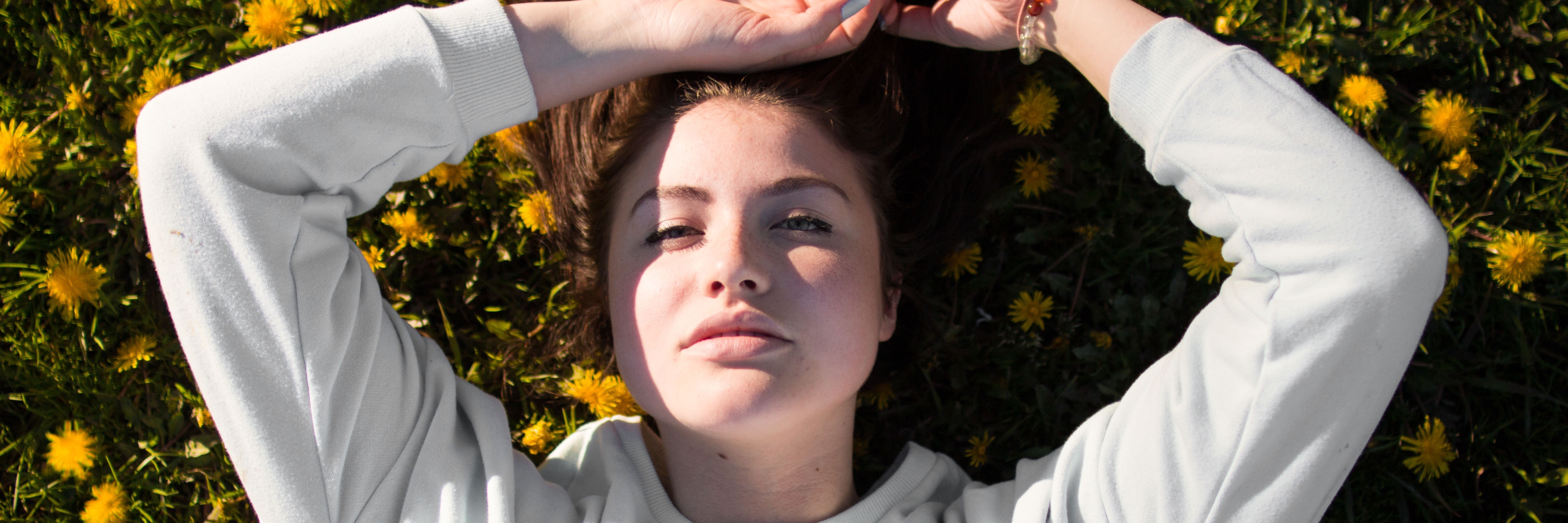 Why I Do Not Define Myself by My Bipolar Disorder woman lying in field of yellow flowers