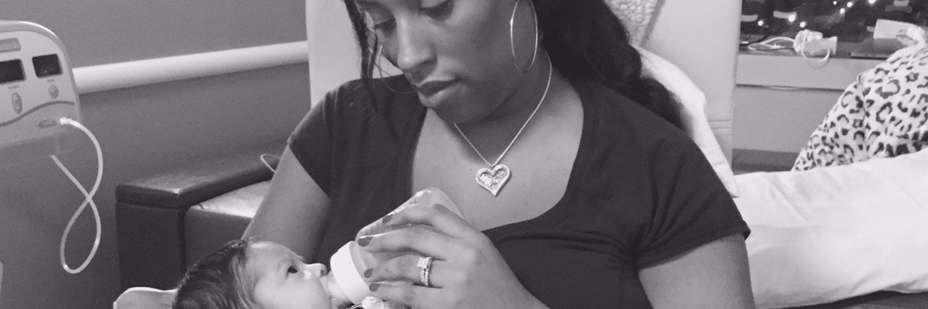 My Baby Has Cancer. No, I'm Not OK. Mother holding her baby, giving her baby a bottle in a hospital room