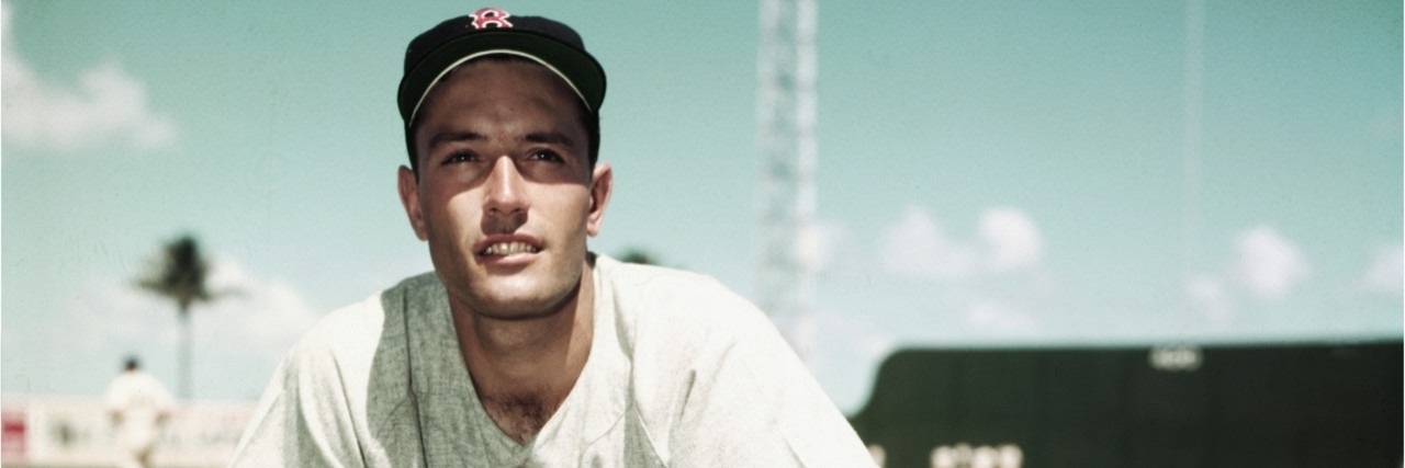 baseball player Jimmy Piersell looks at camera standing on baseball field