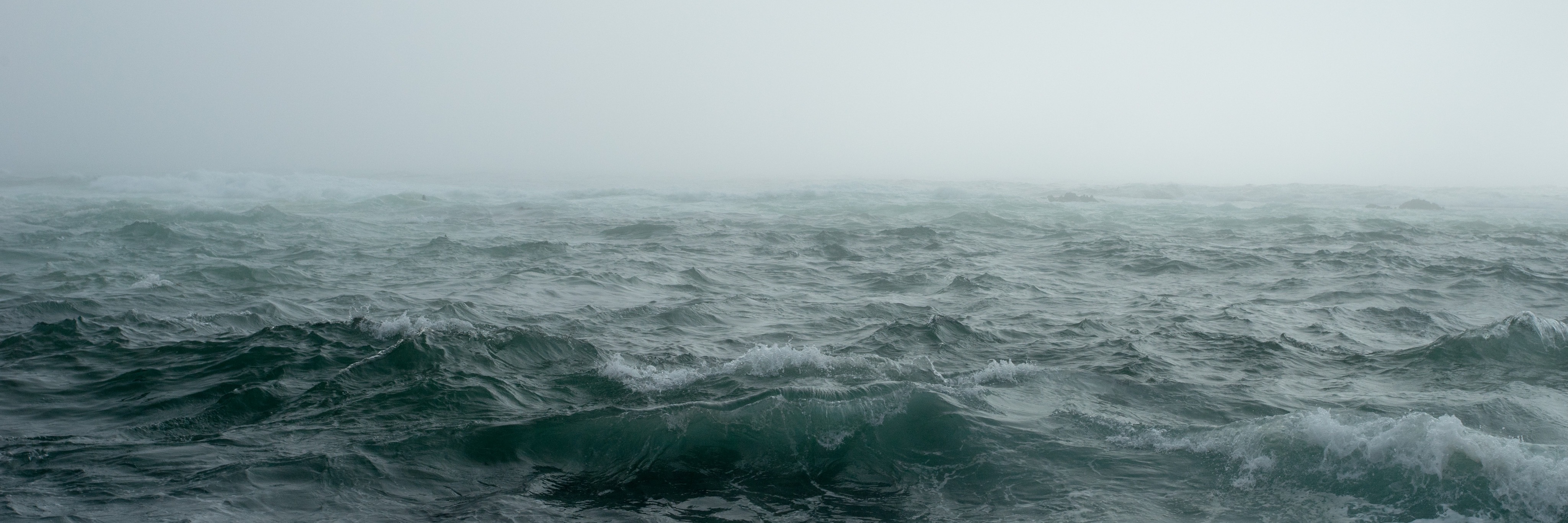 misty ocean scene during storm with rough waves