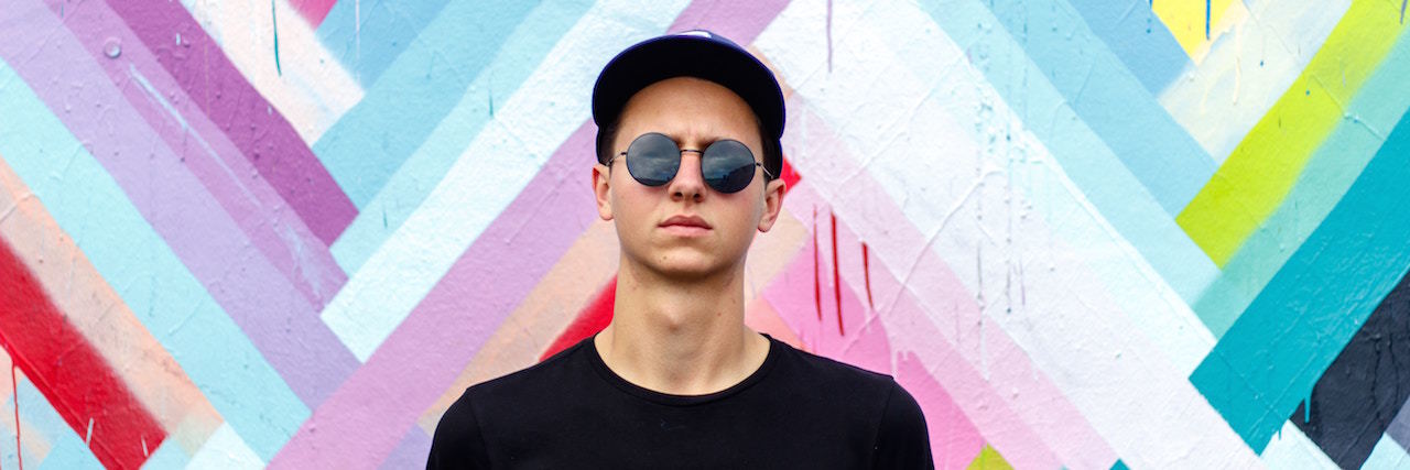 Using My Experience as a Male in Anorexia Recovery to Help Others man in front of colored background