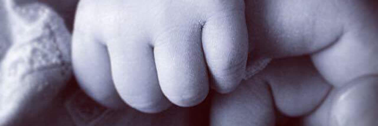 My Experience Being Pregnant as Someone With Paranoid Schizophrenia contributor hand with daughter