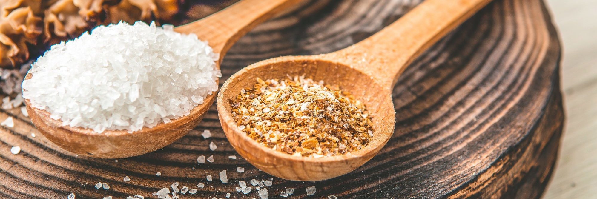 What Spoon Theory Means for Mental Illness two wooden spoons holding salt and pepper on wooden board in warm light