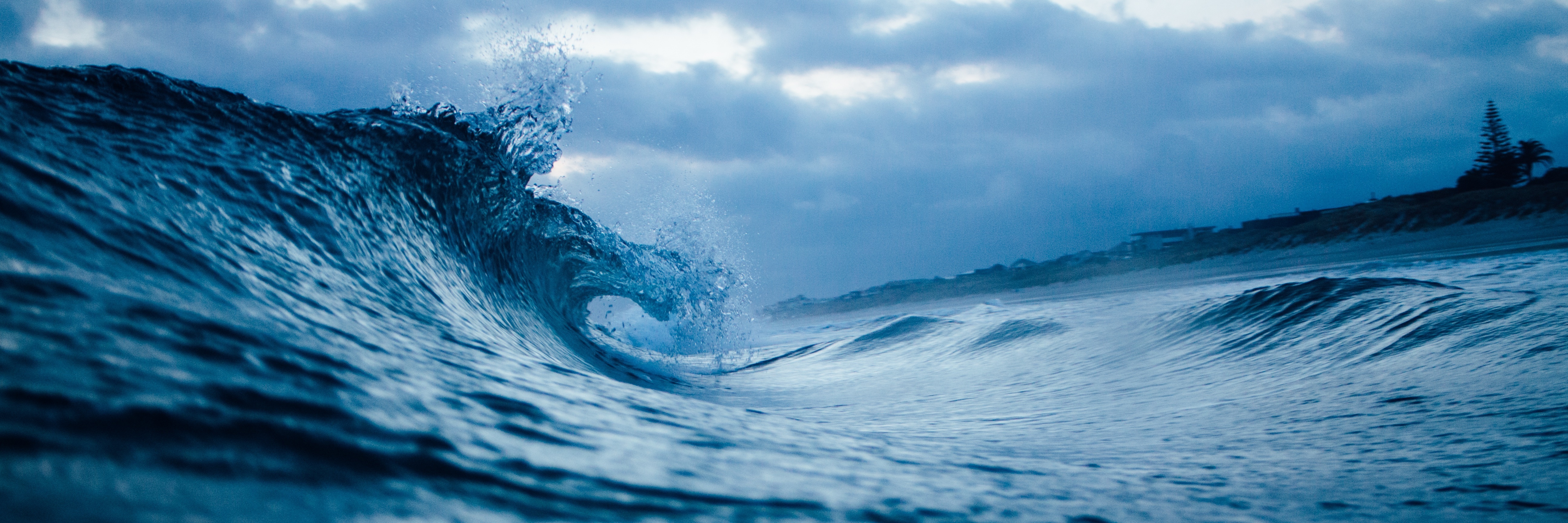 Reaching out for Support and Lifeguards During Depression ocean wave on dark day heading towards shore