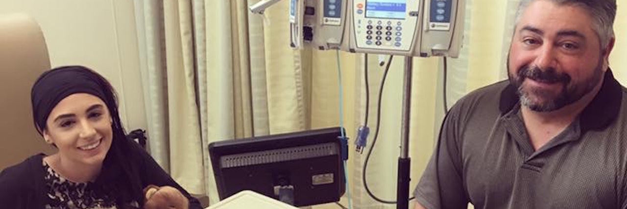 Learning to Share and Talk Openly About Behcet's Disease woman receiving an infusion and smiling next to a man