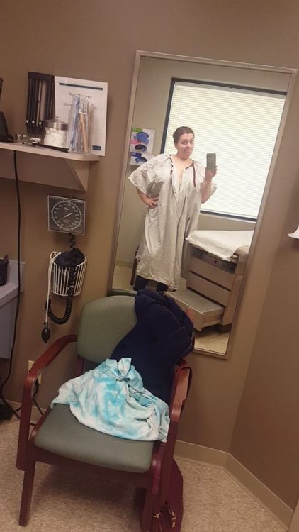 woman wearing a hospital gown in a doctor's office