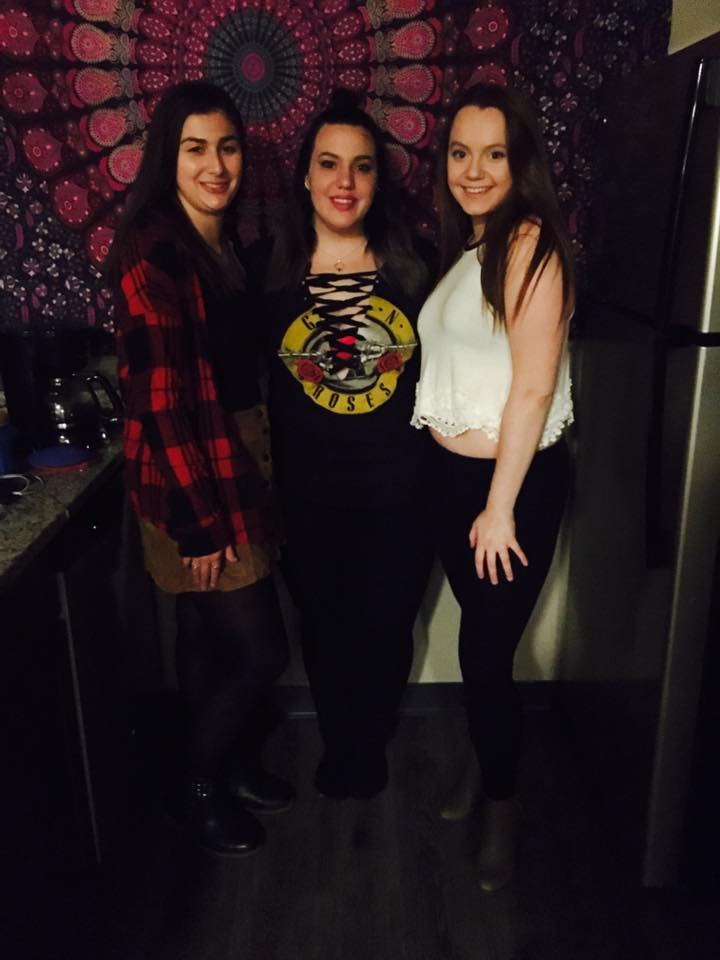 three young woman standing together smiling