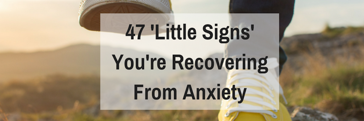 47 'Little Signs' You're Recovering From Anxiety A person walks peacefully in nature, closeup of their yellow converse shoes stepping up over rock. Transcription: 47 'Little Signs' You're Recovery From Anxiety.