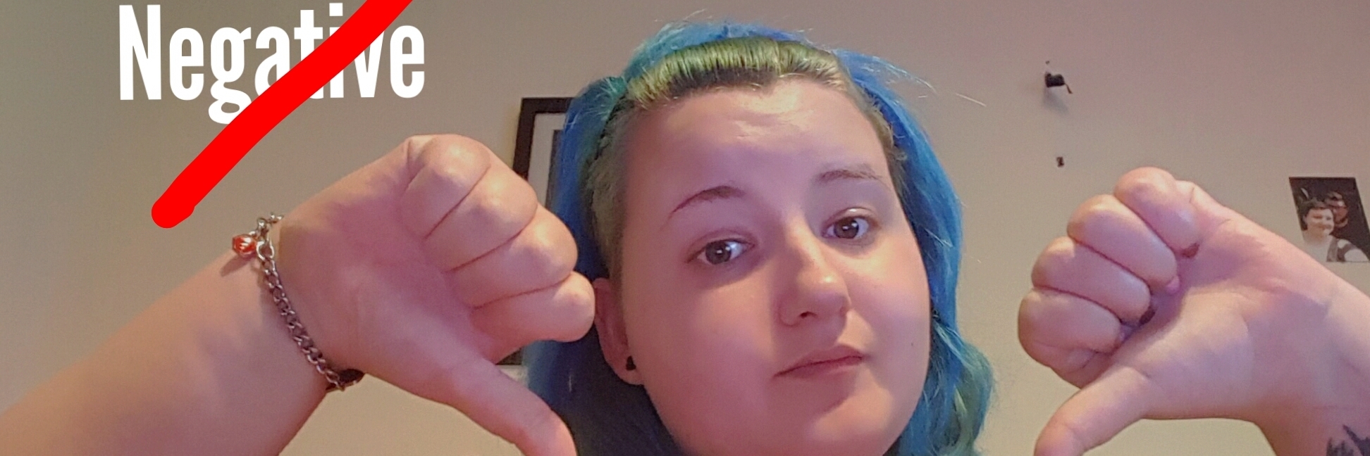 Why You Shouldn't Tell Someone With Chronic Illness Not to Be Negative woman giving a thumbs down with the word 'negative' crossed out