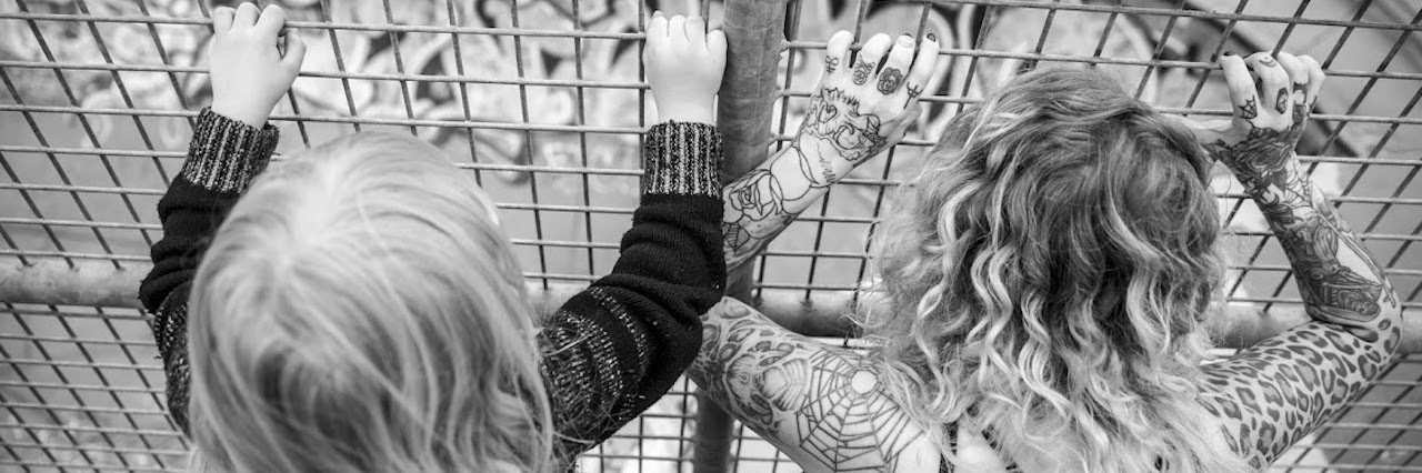 Arthritis: My Insecurities as a Single Mother With Chronic Illness black and white photo of mother and son looking through wire fence