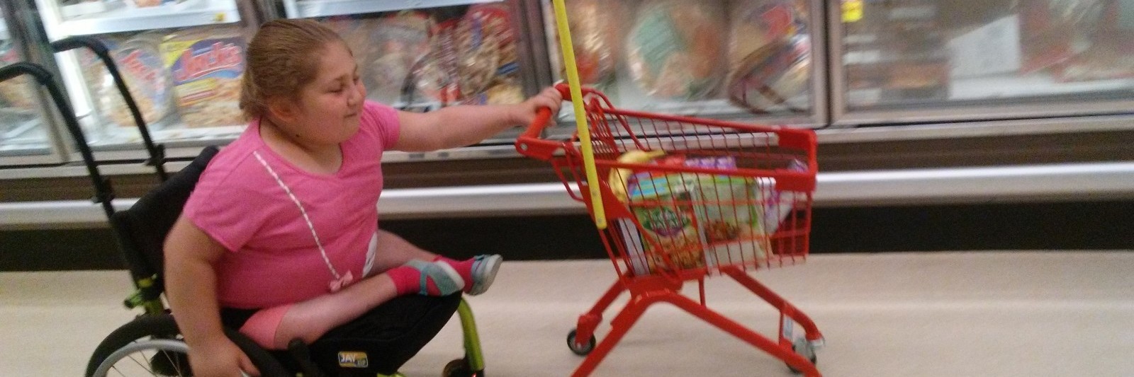 My Daughter Pushed a Grocery Cart and Wheeled Herself Independently Namine pushing a shopping cart with one hand