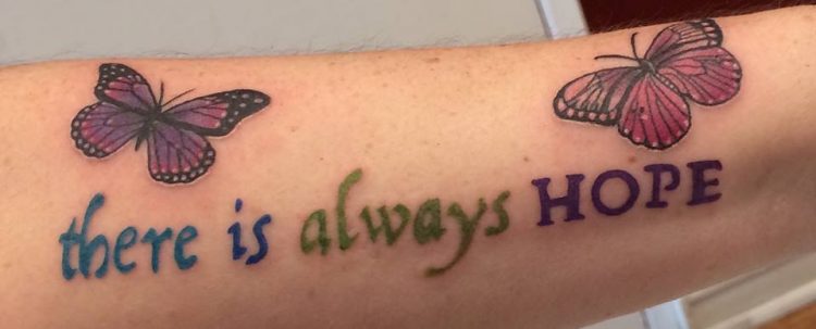 tattoo on woman's arm that says 'there is always hope'