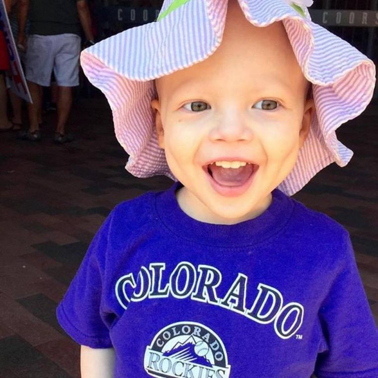 young cancer patient in hat smiling