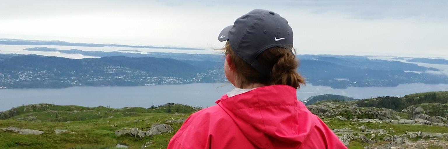 Disney Dreams of Happily Ever After With Chronic Illness woman standing on a fjord in norway