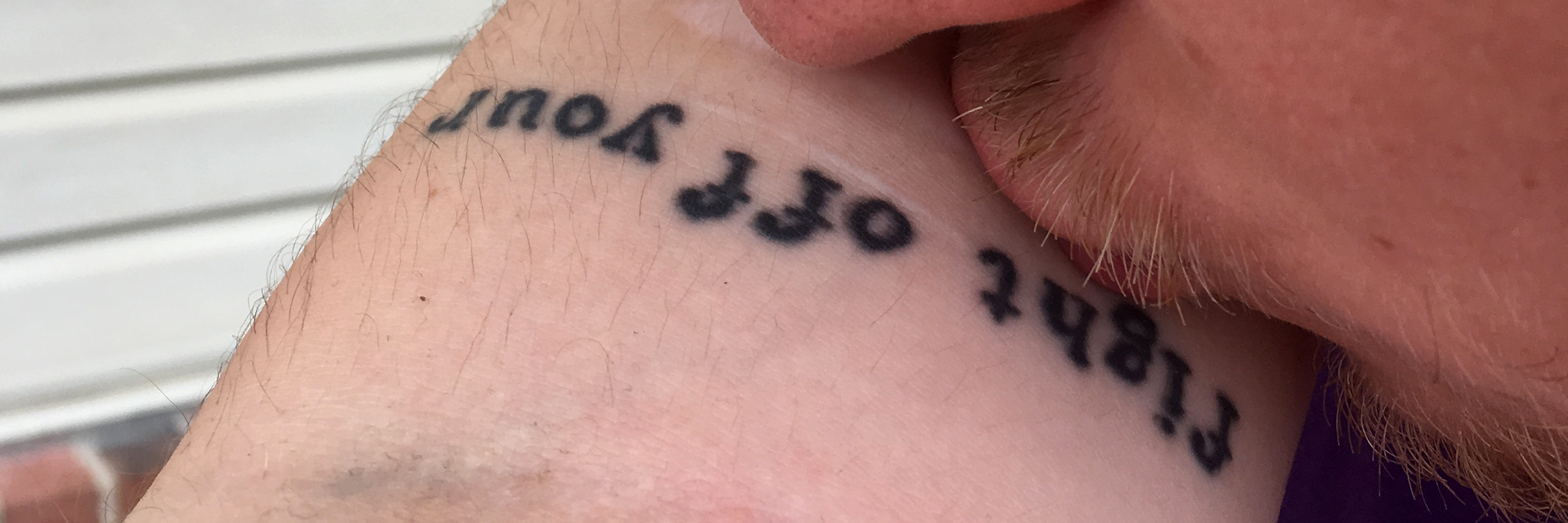How Love Is Possible, Even With Mental Illness image of man kissing woman's arm with self-harm scars and tattoo
