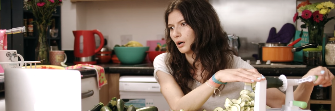 A woman peeling Zucchini