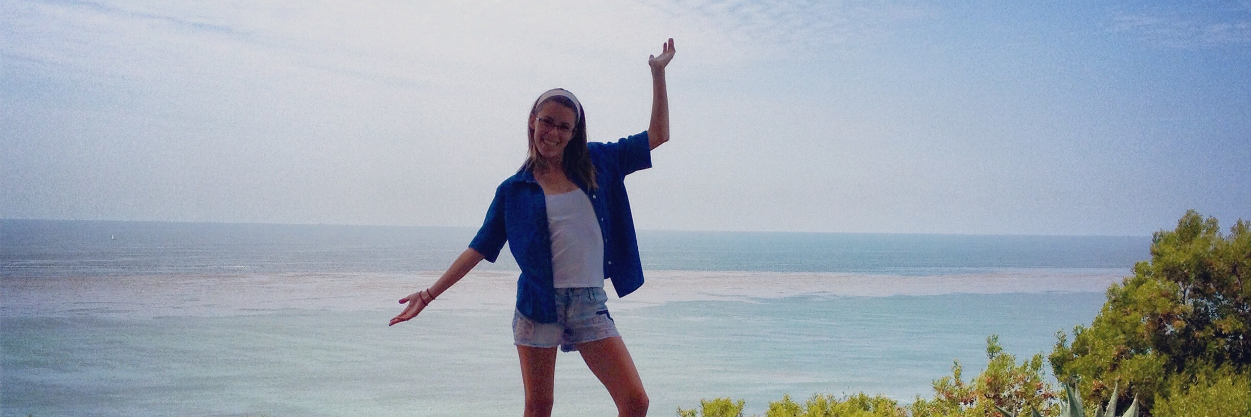 When a Girl Wanted to Have Celiac Disease to 'Be Skinny' woman standing on table that overlooks the ocean