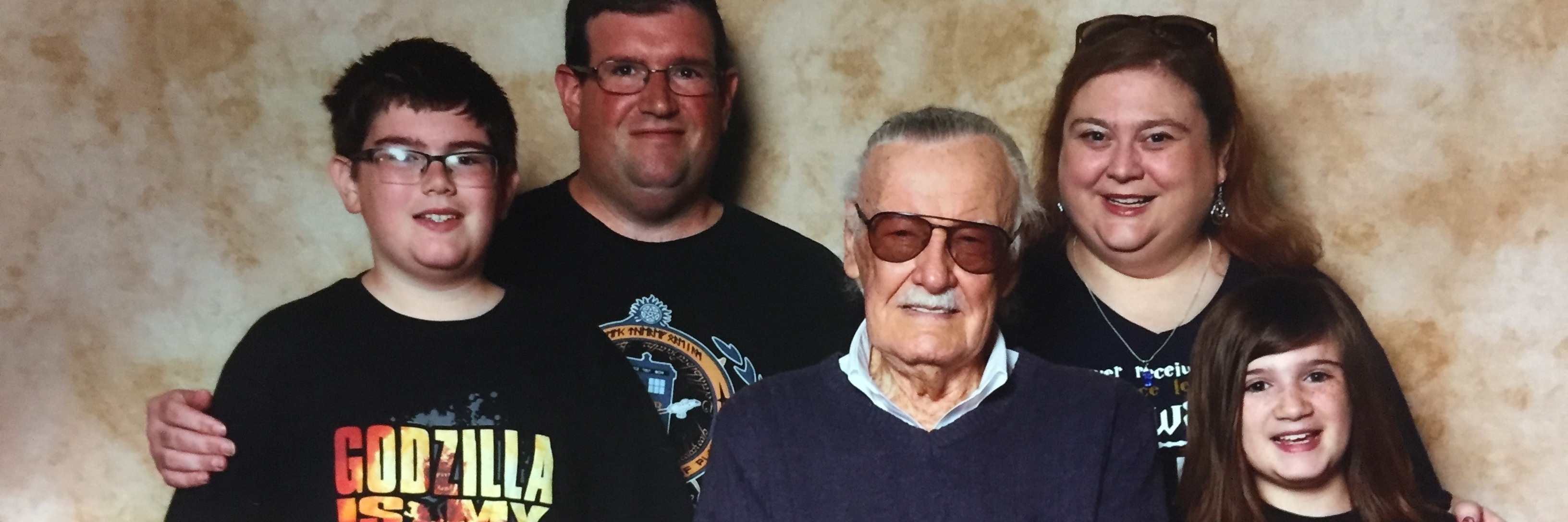 Judging People With Illnesses for Posting Pictures From Events Online amanda's family posing in marvel shirts with stan lee