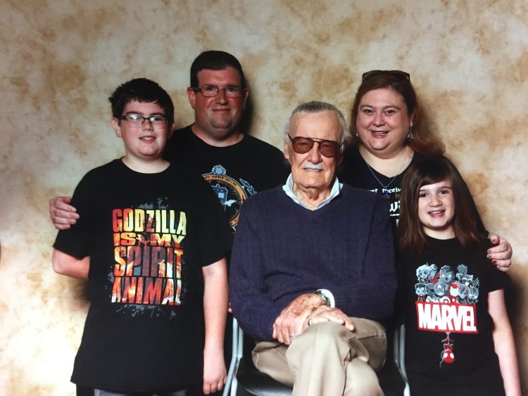 amanda's family posing in marvel shirts with stan lee